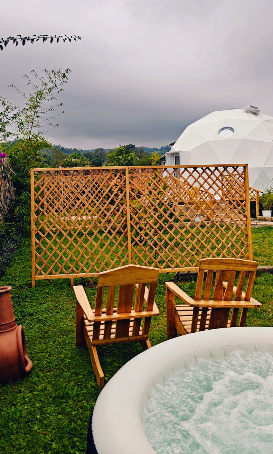 The plunge pool and loungers on the lawn beside a dome