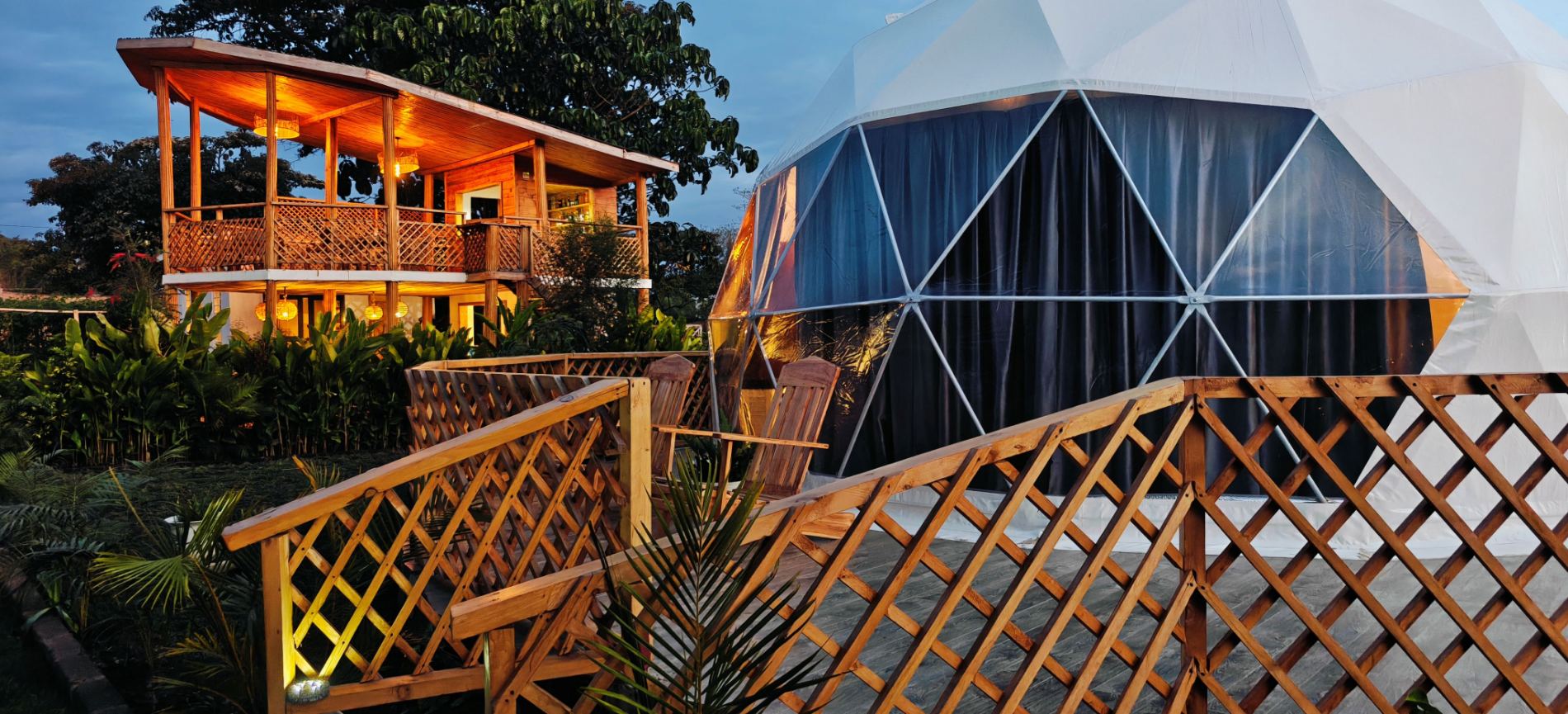 The treehouse restaurant and a dome lit at dusk
